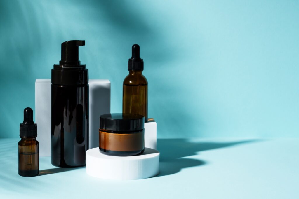 Natural Cosmetic products on blue background. Shampoo, masr and cream with Trendy shadows.