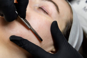 Woman closes her eyes as a gloved professional performs one of our facials near Mountain Lakes, NJ.