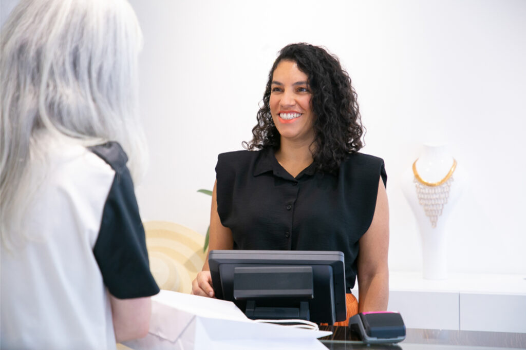 A member of the Exhibit Medical Aesthetics team smiles as a patient as they check-in to learn more about laser skin resurfacing in Denville.