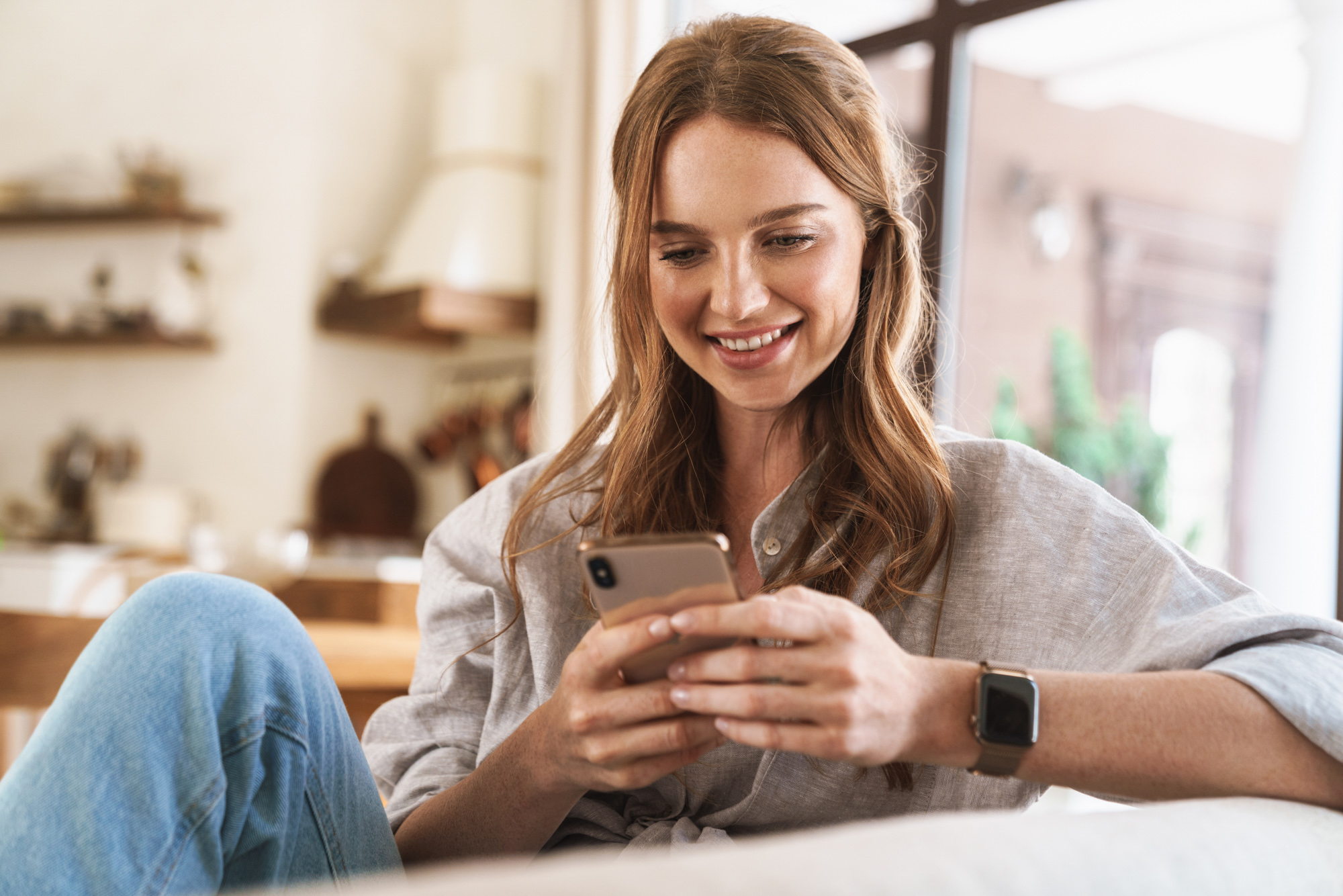 Woman smiling and looking at phone