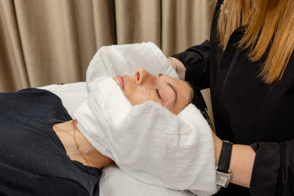 Nurse holds towel on patient's chin