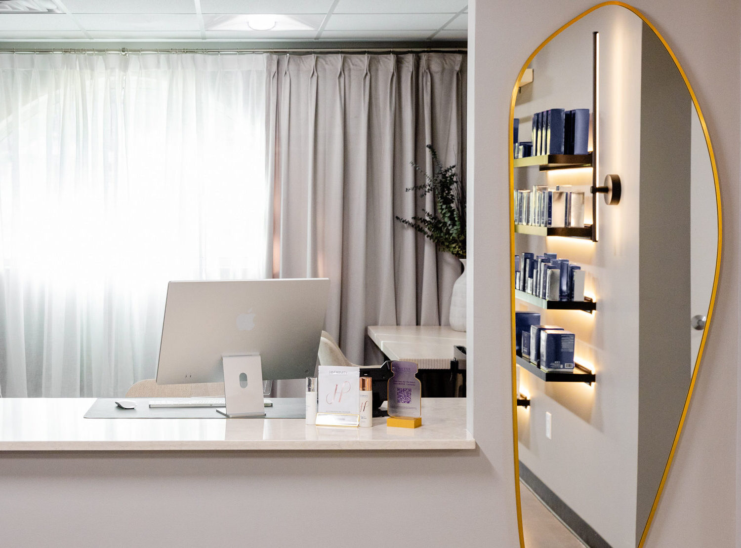 The concierge desk at Exhibit Medical Aesthetics, where many patients are welcomed by the team when they check in for treatments, including filler near Madison, NJ.