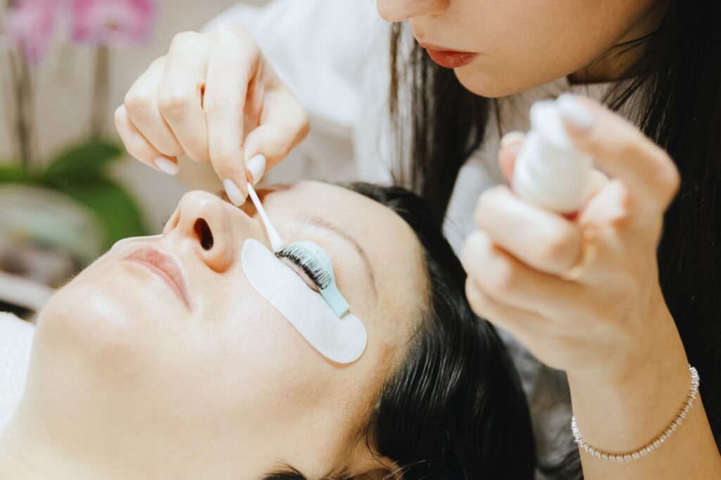 A provider at Exhibit Medical Aesthetics lifts a patient's lashes after completing a lash tint near Mountain Lakes, NJ.