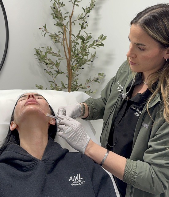 A blonde female provider at Exhibit Medical Aesthetics helping a female patient reverse wrinkles by providing injections of Dysport near Mountain Lakes, NJ.