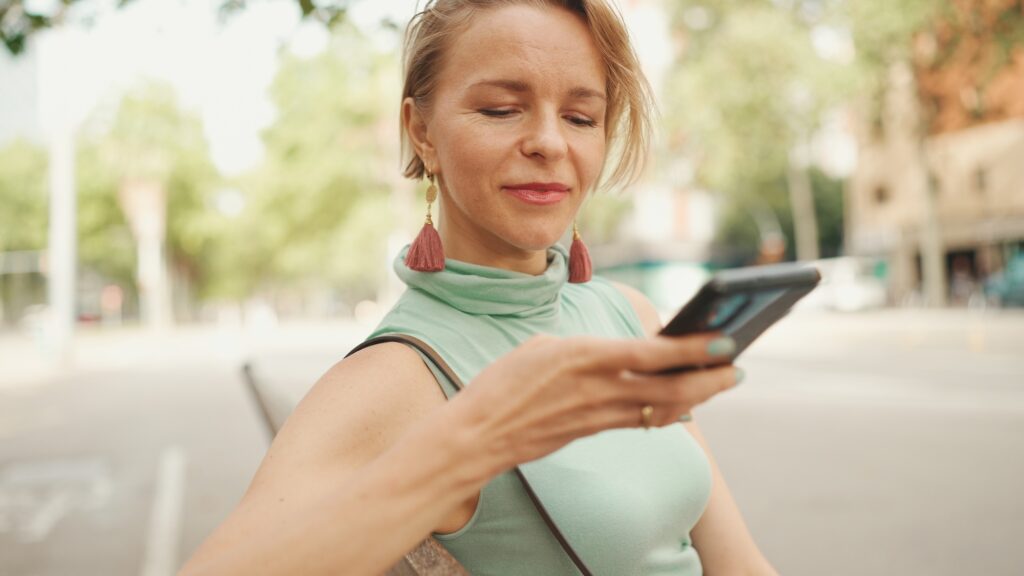 Woman looking at the Exhibit Medical Aesthetics website to learn more about their wide variety of services, including lip filler near Mountain Lakes, NJ.